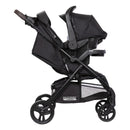 Load image into gallery viewer, Side view with the car seat on the Baby Trend Passport Carriage DLX Stroller