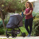 Load image into gallery viewer, Mom strolling outdoor with her child in the Passport Carriage Stroller by Baby Trend