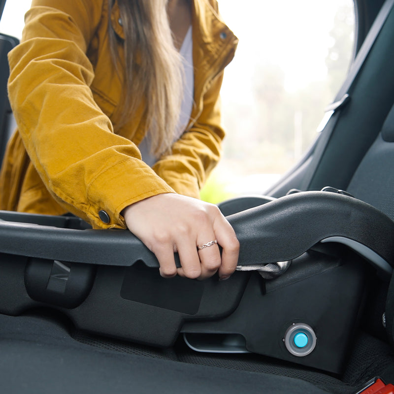 A mom is installing the car seat base into her car using the Baby Trend EZ-Lift 35 PLUS Infant Car SeatBaby Trend EZ-Lift 35 PLUS Infant Car Seat