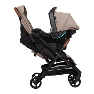 Side of the Baby Trend York Compact Stroller with an infant car seat attached