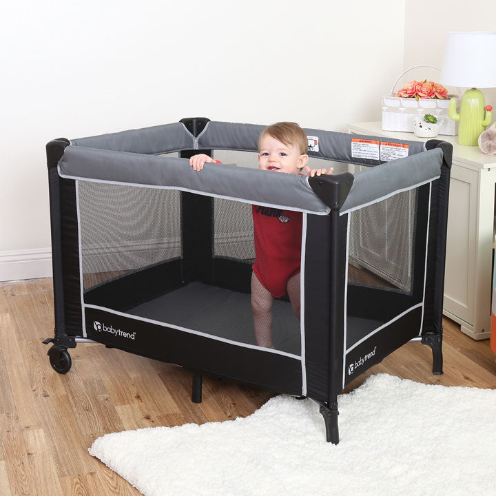 Toddler inside the Baby Trend Classic Nursery Center Playard