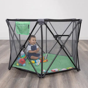 A child is playing and sitting in the Baby Trend Play Zone Pop-up Play Pen