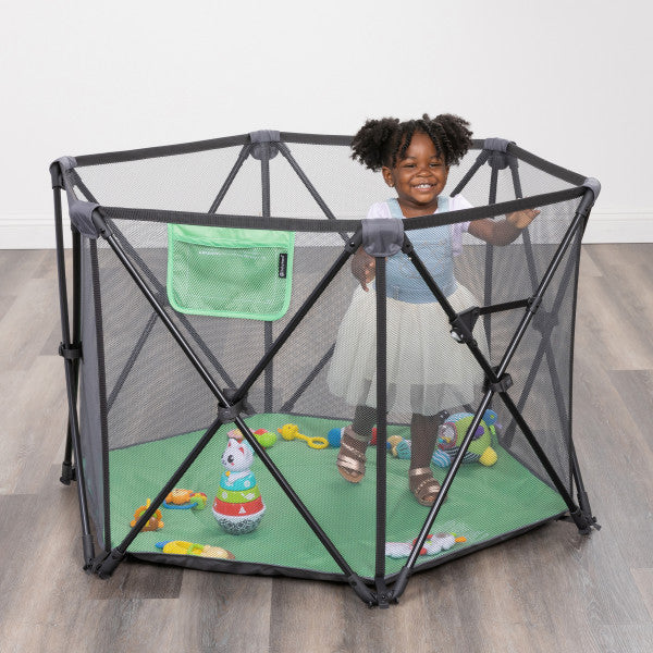A child playing in the Baby Trend Play Zone Pop-up Play Pen