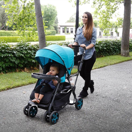 Woman pushing baby in Baby Trend stroller