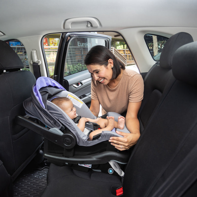 Mom is looking at her child sitting on Baby Trend EZ-Lift 35 PRO Infant Car Seat in the car