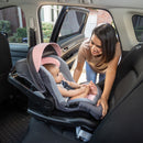Load image into gallery viewer, Mom is making sure her child is sitting comfy in the back seat of her car in the Baby Trend Secure-Lift 35 Infant Car Seat