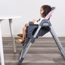 Load image into gallery viewer, Toddler girl sitting at the dining table on the Baby Trend Sit Right 2.0 3-in-1 High Chair
