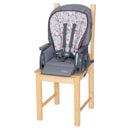 Load image into gallery viewer, Booster mode with the seat on a dining chair from the MUV by Baby Trend 7-in-1 Feeding Center High Chair