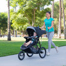 Load image into gallery viewer, Mom is out having a run with her toddler jogging with the Baby Trend Expedition Race Tec Plus Jogger Stroller