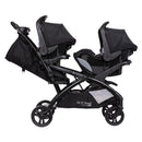 Load image into gallery viewer, Side view of the Baby Trend Sit N' Stand Double 2.0 Stroller with car seat in the front and rear seats, infant car seat sold separately