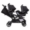 Side view of the Baby Trend Sit N' Stand Double 2.0 Stroller with car seat in the front and rear seats, infant car seat sold separately