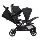 Load image into gallery viewer, Side view of the Baby Trend Sit N' Stand Double 2.0 Stroller with infant car seat in the rear seat, infant car seat sold separately