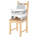 Load image into gallery viewer, Baby Trend Portable High Chair sitting on a dining chair