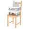 Baby Trend Portable High Chair sitting on a dining chair