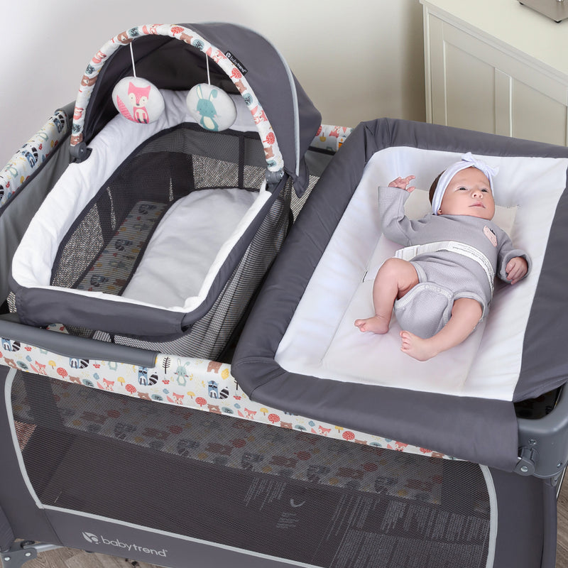 Infant laying on the changing table for a change of the Baby Trend Lil’ Snooze Deluxe II Nursery Center Playard