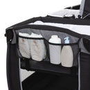 Load image into gallery viewer, Side storage pocket of the Baby Trend Lil' Snooze Deluxe Plus Nursery Center Playard 