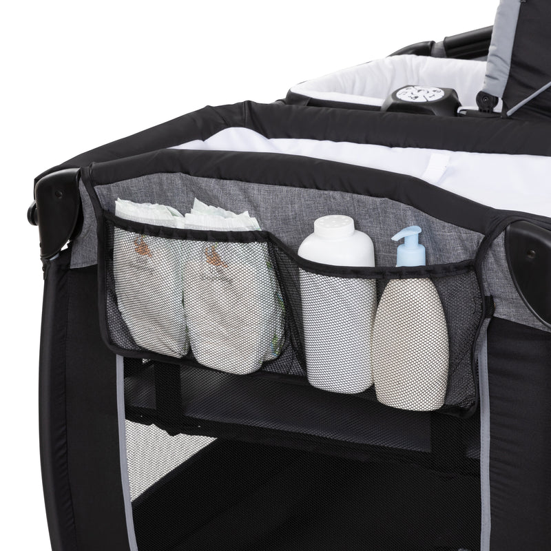 Side storage pocket of the Baby Trend Lil' Snooze Deluxe Plus Nursery Center Playard 