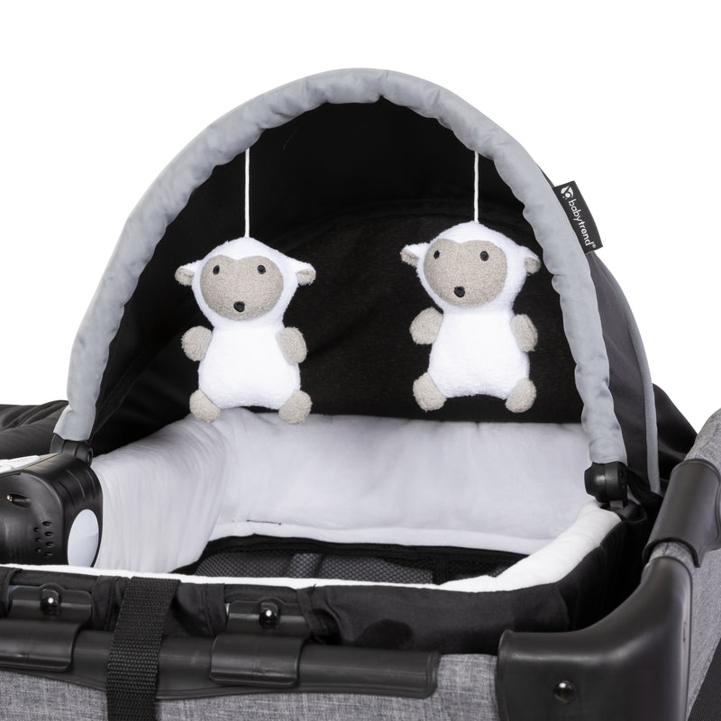 Two hanging toys on the napper of the Baby Trend Lil' Snooze Deluxe Plus Nursery Center Playard 
