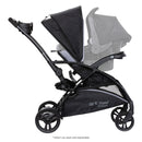 Load image into gallery viewer, Side view of the Baby Trend Sit N Stand 5-in-1 Shopper Stroller with infant car seat attached for a travel system, sold separately