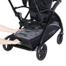 Load image into gallery viewer, Large storage basket with rear basket access from the Baby Trend Sit N Stand 5-in-1 Shopper Stroller