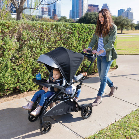 Baby Trend Sit N Stand 5-in-1 Shopper Stroller with mother and two children in one stroller
