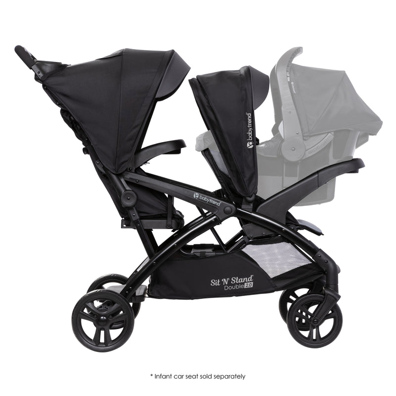 Side view of the Baby Trend Sit N' Stand Double 2.0 Stroller with a car seat in front