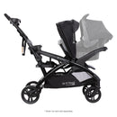 Load image into gallery viewer, Side view of the Baby Trend Sit N' Stand Double 2.0 Stroller with infant car seat in the front and back seat as a jump seat