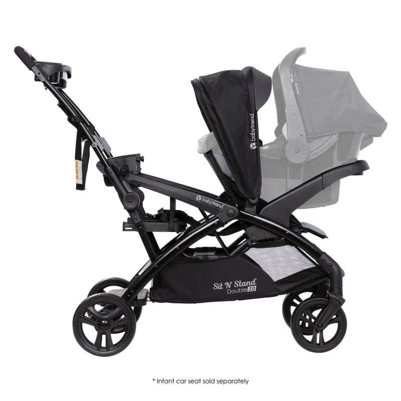 Side view of the Baby Trend Sit N' Stand Double 2.0 Stroller with infant car seat in the front and back seat as a jump seat