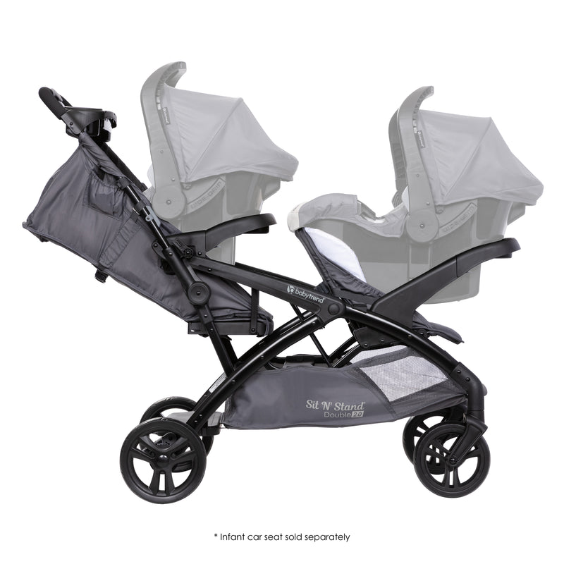 Side view of the Baby Trend Sit N' Stand Double 2.0 Stroller with an infant car seat in the front and rear seat for a travel system