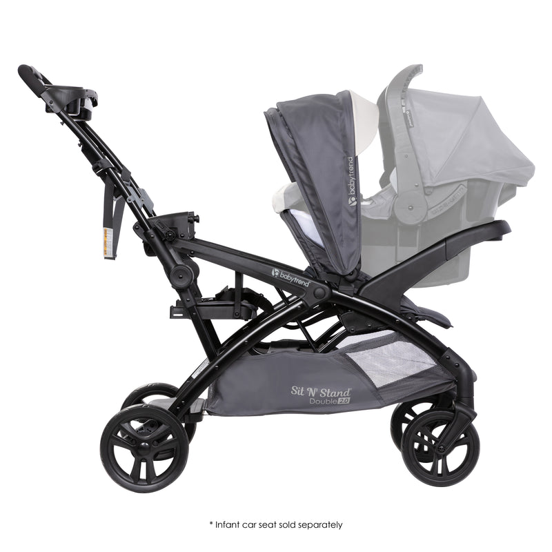 Side view of the Baby Trend Sit N' Stand Double 2.0 Stroller with an infant car seat in the front and rear as a jump seat