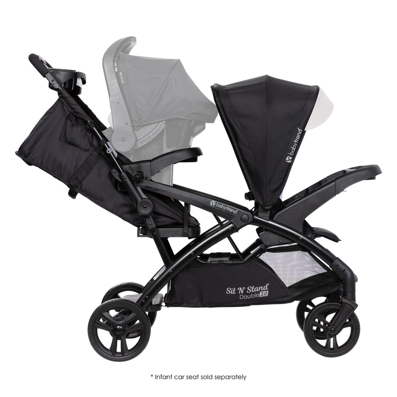 Side view with car seat in the rear seat of the Baby Trend Sit N' Stand Double 2.0 Stroller, infant car seat sold separately