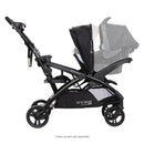 Load image into gallery viewer, Side view of the Baby Trend Sit N' Stand Double 2.0 Stroller with car seat in front seat and rear seat as jump seat or stand on platform, infant car seat sold separately