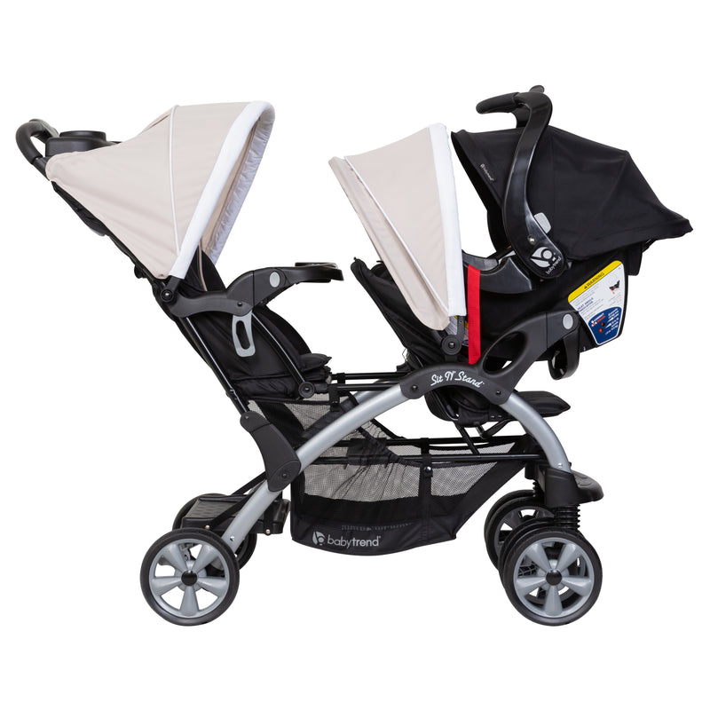 Baby Trend Sit N' Stand Double Stroller side view of the rear seat and front seat holding an infant car seat