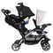 Baby Trend Sit N' Stand Double Stroller side view of child front seat and rear seat being used as a travel system with an infant car seat