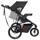 Load image into gallery viewer, Side view of the child reclining on the Baby Trend Pro Steer Jogger Stroller Travel System