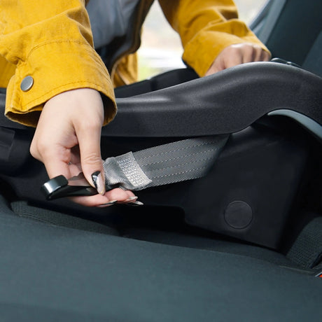 Mom is using the latch system to install the Baby Trend EZ-Lift 35 Infant Car Seat