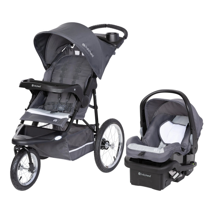Baby Trend Expedition Jogger Travel System in gray: a three-wheel jogging stroller with bicycle tires beside its infant car seat and base