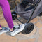Mom is using the brakes on the Baby Trend Tango 3 All-Terrain Stroller Travel System