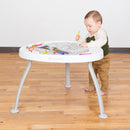 Load image into gallery viewer, A boy is coloring in the coloring book on the Convert the Baby Trend 3-in-1 Bounce N Play Activity Center as a table