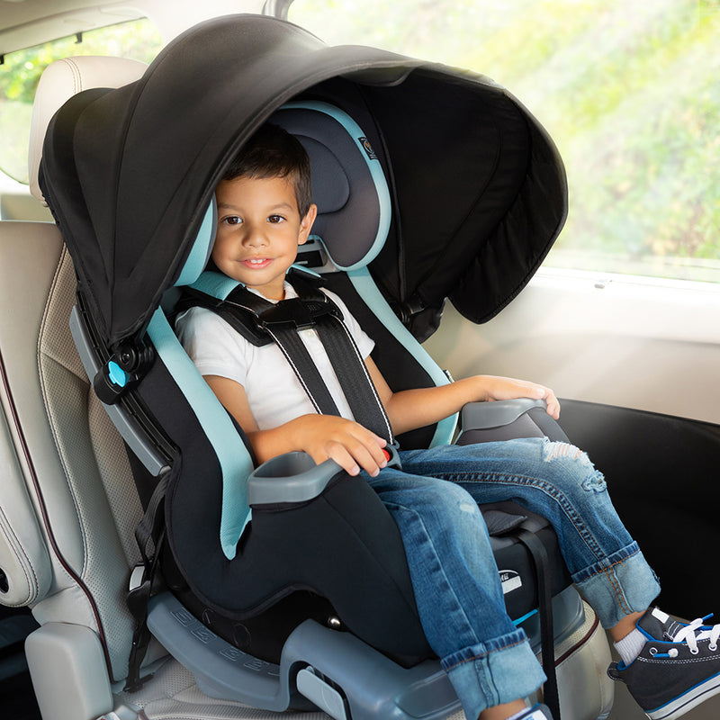 Toddler boy sitting in the Baby Trend Cover Me 4-in-1 Convertible Car Seat