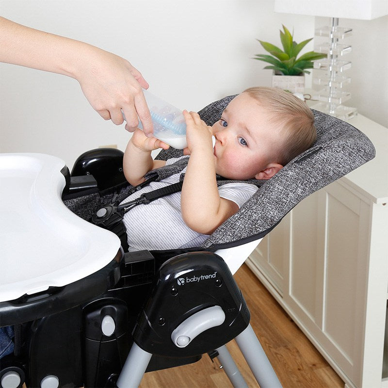 Baby is being feed while sitting on the Baby Trend A La Mode Snap Gear 5-in-1 High Chair
