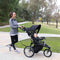 Parent strolling with her child in the Baby Trend Quick Step Jogging Stroller