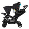 Baby Trend Sit N' Stand Double Stroller with front  seat child sitting and rear seat with an infant car seat