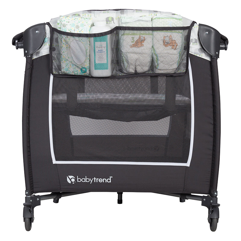 Side storage pocket for diapers and accessories on the Baby Trend Lil' Snooze Deluxe II Nursery Center Playard