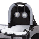 Load image into gallery viewer, Two hanging toys on the Rock-A-Bye bassinet of the Baby Trend Deluxe CLX Nursery Center Playard