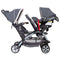 Baby Trend Sit N' Stand Double Stroller with infant car seat in the front seat and child sitting in the rear seat