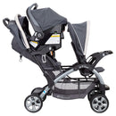 Load image into gallery viewer, Baby Trend Sit N' Stand Double Stroller with child sitting in front and infant car seat in the back seat