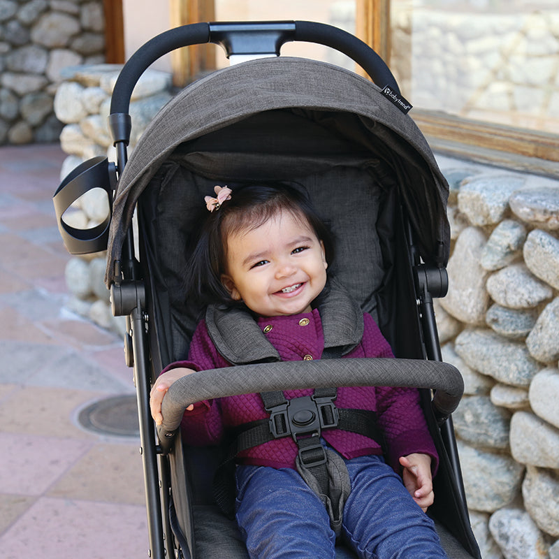 Baby is happily sitting comfortably in the Baby Trend Jetaway Compact Stroller lightweight stroller 