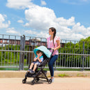 Load image into gallery viewer, Mom and her child strolling through the outdoor exploring with the Baby Trend Tango Mini lightweight Stroller
